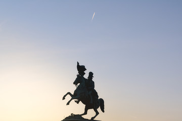 Silhouette of equestrian statue of Archduke Charles in front of Hofburg Palace in Vienna, Austria