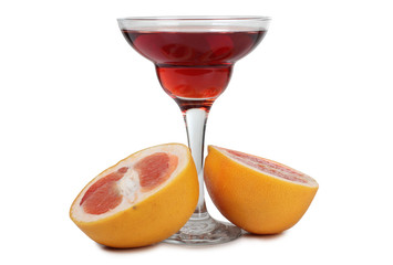 Grapefruit juice in glass goblet on a white background