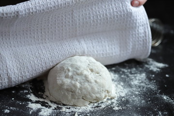 we prepare ourselves yeast and yeast-free dough for pizza and pies on a dark background