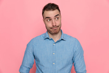 casual man looking aside, wearing a blue shirt