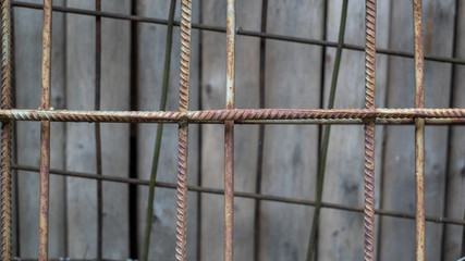 Metal reinforcement bars on a wooden background. Building structure.