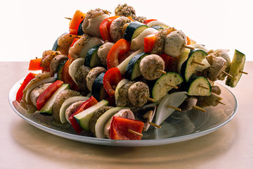Delicious skewers with peppers, onions, chicken, zucchini and mushrooms.