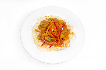 Boiled noodles with gravy of vegetables, chicken breast and mushrooms on a white plate on a white background