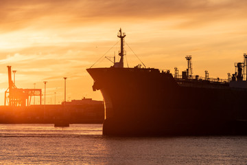 Profile of a tanker ship at sunset.