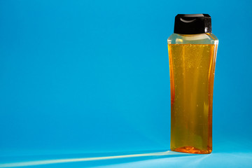 bottle with cream, shampoo for hair, shower gel, colored background, beautiful studio light, beauty and youth of the human body