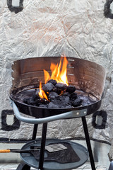 Lighting a charcoal grill. Flames.