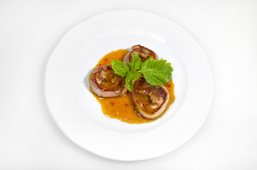 Meatloaf in spicy sauce on a white plate on a white background