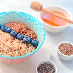 Buckwheat porridge in a bowl with flax seeds and blueberries. oncept healthy food, detox, diet, breakfast