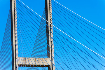 Cables of a suspension bridge create an abstract composition, and represent the concept of infrastructure.