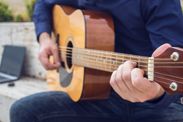 Fototapeta premium Young guy plays guitar
