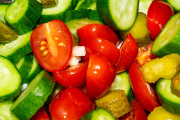 Vegetable salad sliced tomatoes, cucumbers, onions and pickles. Close up. Healthy food, fitness diet.