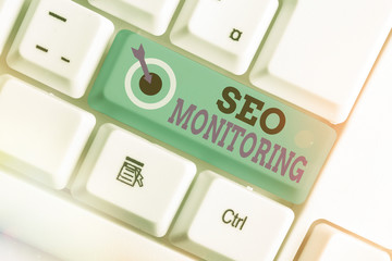 Writing note showing Seo Monitoring. Business concept for Tracking the progress of strategy made in...