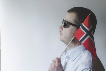 A man with a norwegian flag. Proud of Norway.