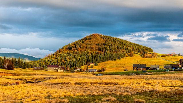 Bukovec mountain above Jizerka village at sunset time. Spring in Jizera Mountains, Czech Republic.