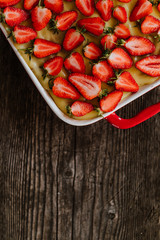 Strawberry cake on the old dark wooden table 