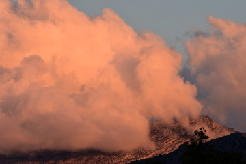Fototapeta premium Cotton candy clouds over the mountain