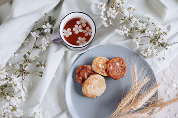 spring healthy Breakfast fried cheesecakes, against a blooming bouquet flowers