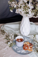 spring healthy Breakfast fried cheesecakes, against a blooming bouquet flowers