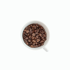 Coffee cup filled with coffee beans isolated on white