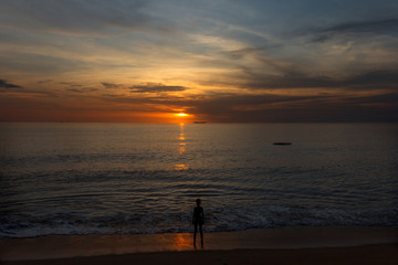 Fototapeta na wymiar The silhouette against the background of an ocean sunset