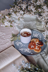 spring healthy Breakfast fried cheesecakes, against a blooming bouquet flowers