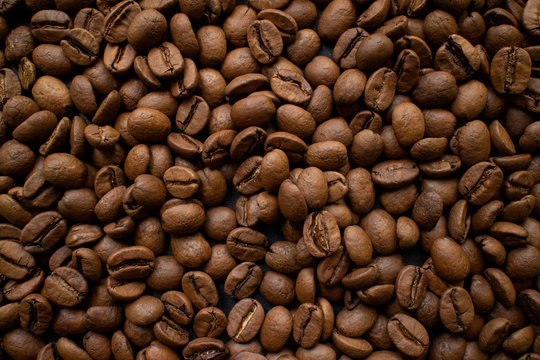 Closeup of roasted coffee beans. Background to the desktop.