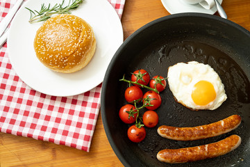 overhead shot of fried breakfast American sausage egg tomatoes roll coffee quick tasty first healthy big portion