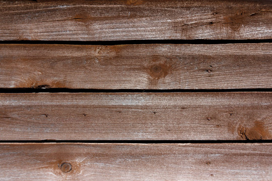 The background is made of wooden boards. The texture of an rustic wooden fence