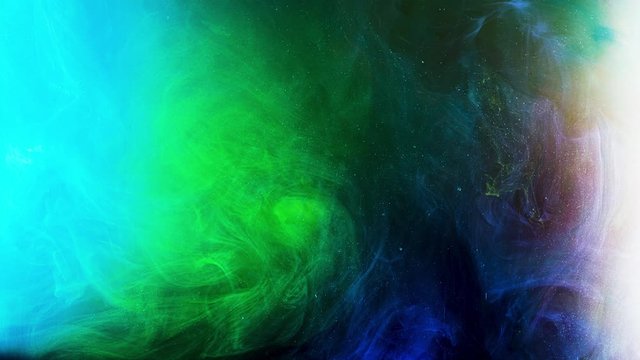 Fluid art background with colorful liquid surface. Stock footage. Amazing effect of mixed blue and green liquid paints with tiny particles, watercolor painting.