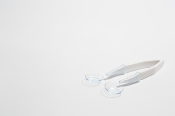 Flat lay composition with contact lenses and accessories on white background