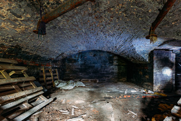 Fototapeta na wymiar Abandoned empty old dark underground vaulted cellar