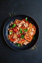 Pasta spaggeti with tuna and tomato sauce. Top view with copy space.