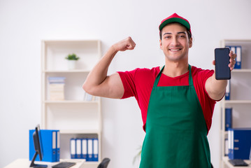 Young male courier delivering pizza to the office