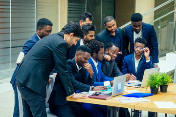 international group of nine african american and indian people having a rest after brain storm in big office