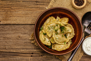 Dumplings stuffed stewed cabbage and sour cream. Traditional Ukrainian dish varenyky