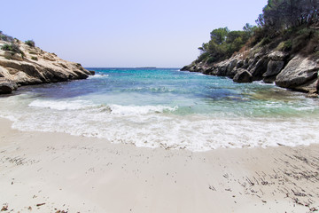 Fototapeta na wymiar Lonely beach with blue sky, Caló de la Bella Dona, Mallorca