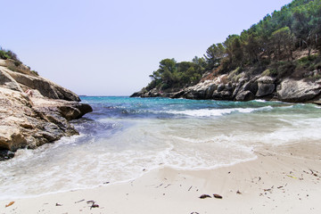 Fototapeta na wymiar Lonely beach with blue sky, Caló de la Bella Dona, Mallorca
