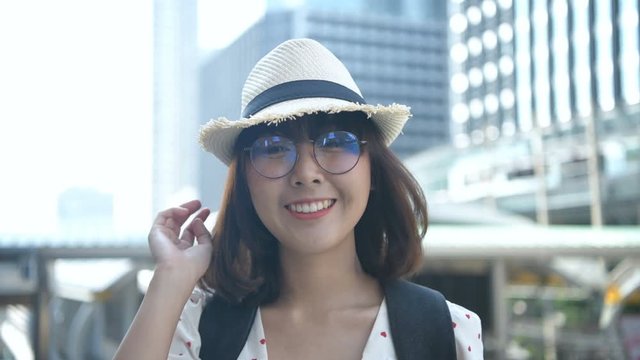 Holiday concept. An Asian woman is smiling inside the city. 4k Resolution.