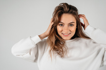 Fototapeta premium Close-up portrait of a beautiful young woman with stylish hairstyle on the white background