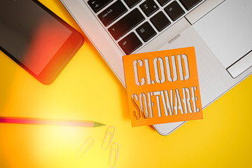 Text sign showing Cloud Software. Business photo showcasing Programs used in Storing Accessing data over the internet Trendy laptop smartphone blank sticky note pencil clips colored background