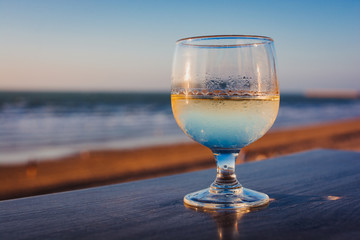 Glass of wine on a table at a beach resort