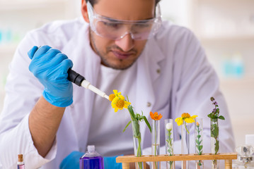 Young male chemist in perfume synthesis concept