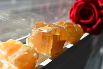 An image of three honey calcite crystals recharging on a sunny window ledge. 