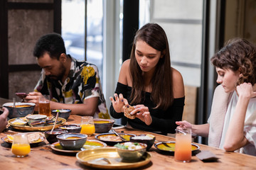 Multicultural students sitting at the table in the common kitche