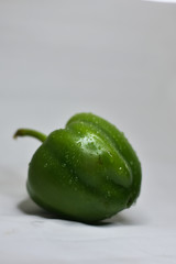 green capsicum on a white background, and the water drops on a fresh capsicum, Indian Vegetable 