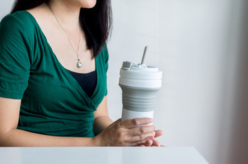 Hand woman holding reusable coffee mug,Healthy green,Zero waste,Environmental friendly,Conscious lifestyle concept