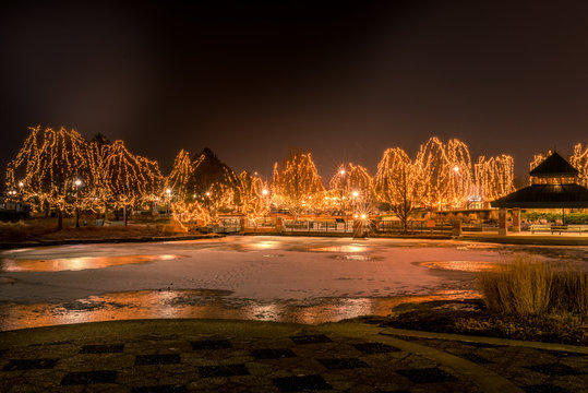 Winter Night Landscape. Frozen Lake And Christmas Lights, Schaumburg, IL