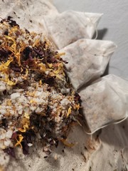 Calendula bath salts and rose petals with almond oil in tea bags.