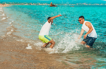 Diverse beach summer friends fun, spraying with water