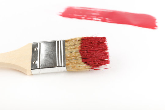 brush stroke of red paint on a white background